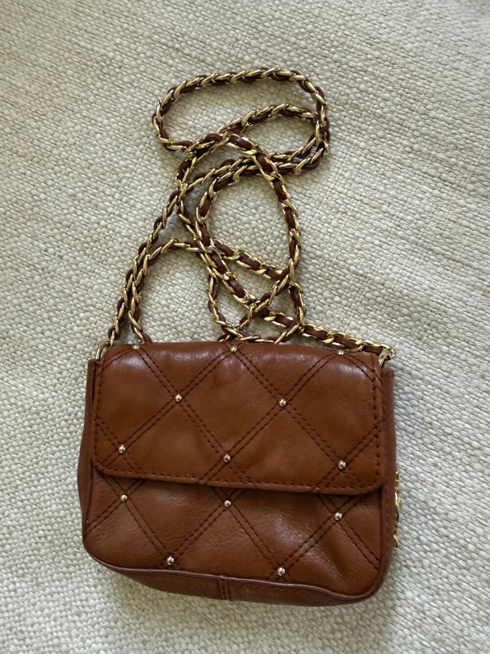Juicy Couture mini crossbody bag in a rich cognac/brown color.